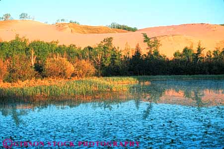 Stock Photo #7123: keywords -  accumulate accumulates accumulation barren bear blown changeable changingr countless deposit desert desiccated dried dry dune dunes dynamic earth environment geologic geological geology grain grains heat horz hot lake lakeshore lifeless marsh michigan movable moving national nature particle particles physical pile pond reflect reflection ripple ripples sand sanddune sanddunes science sediment sedimentary sedimentation sleeping water wind