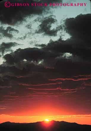 Stock Photo #7293: keywords -  climate cloud clouds dawn dusk landscape mood moody mountain mountains nature scenery scenic sun sunrise sunset vert warm weather