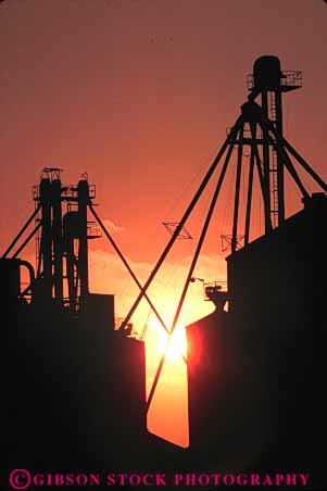 Stock Photo #7335: keywords - agriculture building buildings dawn dusk elevator elevators equipment evening farm farming farms grain manmade mood moody morning silhouette silhouettes silo silos structure sun sunrise sunset vert warm