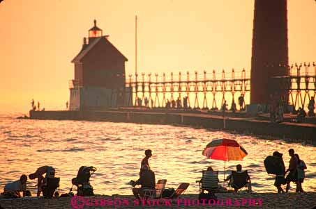 Stock Photo #7338: keywords - beach building buildings dawn dusk evening grand haven horz house lake landscape light lighthouse manmade michigan mood moody orange people red resort scenery scenic silhouette silhouettes structure summer sun sunrise sunset tower travel vacation warm water