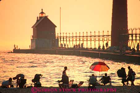 Stock Photo #7338: keywords -  beach building buildings dawn dusk evening grand haven horz house lake landscape light lighthouse manmade michigan mood moody orange people red resort scenery scenic silhouette silhouettes structure summer sun sunrise sunset tower travel vacation warm water