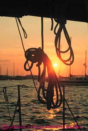 Stock Photo #7351: keywords -  boater boating boats coast coastal coil coiled dawn dusk evening line lines manmade marine maritime mood moody motorboat ocean rope ropes sail sailboat sea shore shoreline silhouette silhouettes structure sun sunrise sunset vert warm water yacht