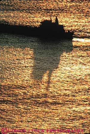 Stock Photo #7353: keywords -  boater boating boats cargo coast coastal commercial dawn dusk evening manmade marine maritime mood moody motorboat ocean open reflecting reflection reflects ripple ripples sea ship shipping shore shoreline silhouette silhouettes stern structure sun sunrise sunset tanker vert warm water wave waves yacht