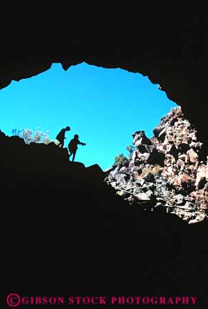 Stock Photo #7425: keywords -  adventure beds california cave caves dark doorway earth entrance environment exit explore exploring formation geologic geological geology hike hikers hole lava monument national nature open opening pair passage people rock rocky science silhouette silhouettes skull stone tunnel two vert volcanic volcano walk walkers