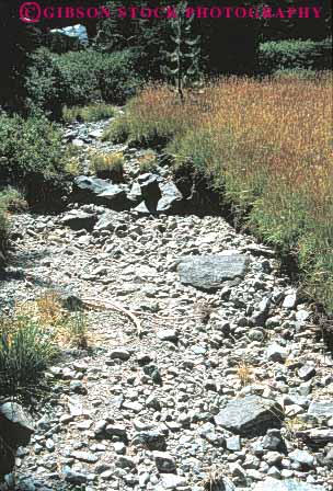 Stock Photo #7451: keywords -  arid bed climate cobble cobbles dried drought dry drying empty environment hot nature parch parched rainless rock rocks stream vert waterless weather