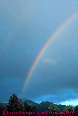 Stock Photo #7025: keywords -  atmosphere atmospheric climate cloud condensate condensation condense condensed condensing cool cooling countryside dark diffract diffracting diffraction distort distortion environment field float floating floats fog gravity light moisture mood moody nature prism rain rainbow rainy rural sky skyward spectrum storm storms stormy suspend suspended tree trees vapor vert water weather wet