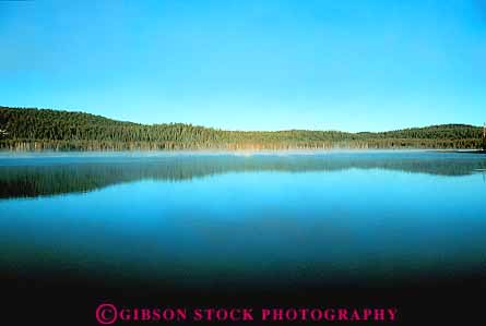 Stock Photo #13864: keywords -  caldera california calm conifer coniferous flat forest horizon horizons horz in lake landscape medicine mirror mirrorlike mirrors nature peaceful quiet reflect reflecting reflection reflects scenery scenic serene still tree trees volcanic water wilderness