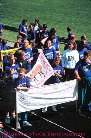 Stock Photo #5529: keywords -  activity and athlete athletic banner child children compete competing competition competitor contest disability disabled disadvantage disadvantaged educate educating education elementary entrance event field group handicap handicapped need needs olympic olympics parade present recreation retarded same school special sport student students team track uniform vert youth