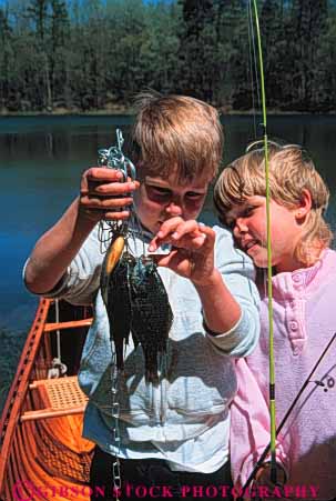 Stock Photo #5538: keywords - boy brother catch caught caution cautious child children count curious examine fish fisherman fishermen girl hold lake look outdoor outdoors outside recreation released see share sibling sister sport stringer study summer sunfish team touch vert water