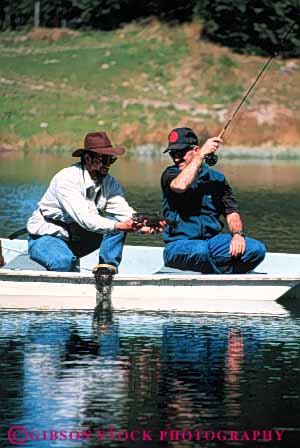Stock Photo #5540: keywords - boat catch caught fish fisherman fishermen fishing guide lake land landed men outboard outdoor outdoors outside pond recreation released small sport summer trout vert water