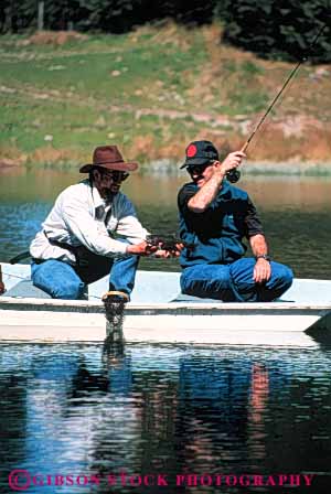 Stock Photo #5540: keywords -  boat catch caught fish fisherman fishermen fishing guide lake land landed men outboard outdoor outdoors outside pond recreation released small sport summer trout vert water