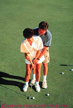 Stock Photo #3535: keywords - affection assist close couple game golf help hug husband learn man putt recreation released sport sports teach together vert white wife woman