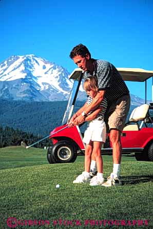 Stock Photo #5554: keywords -  child children club country course dad daughter father girl golf golfer golfers golfing grass green lawn learn man outdoor outdoors outside parent practice recreation released single skill sport summer teach teaching team vert youth