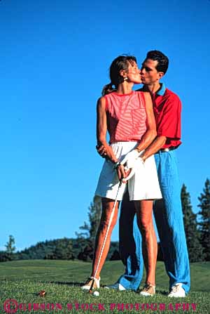 Stock Photo #5555: keywords -  affection club country couple course golf golfer golfers golfing grass green hug husband intimate kiss lawn outdoor outdoors outside practice recreation released share skill smooch sport spouse together vert wife