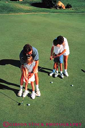 Stock Photo #5556: keywords - boy brother club country course daughter families family father girl golf golfer golfers golfing grass green husband lawn learn man mother outdoor outdoors outside people person practice putt recreation released sibling sister skill son sport together togetherness vert wife woman