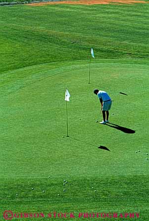 Stock Photo #5557: keywords -  alone club concentrate concentration country course golf golfer golfers golfing grass green lawn man outdoor outdoors outside practice private putting quiet recreation serene skill solitary solitude sport summer vert