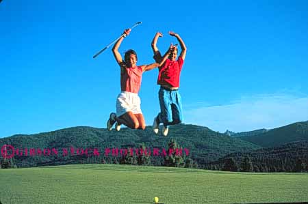 Stock Photo #5568: keywords - club country couple course express expression golf golfer golfers golfing grass green horz joy jump lawn leap outdoor outdoors outside practice recreation released share skill sport summer thrill together