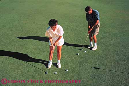 Stock Photo #5570: keywords -  club country couple course golf golfer golfers golfing grass green horz husband lawn man outdoor outdoors outside practice putting recreation released skill sport summer together two wife woman