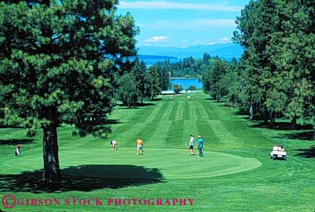 Stock Photo #5573: keywords -  club country course flathead golf golfer golfers golfing grass green horz lake lawn montana mt outdoor outdoors outside practice recreation skill sport summer