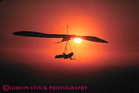 Stock Photo #5576: keywords - air alone calm danger drift dusk equipment fall flight float floating fly flyer flying glide glider gliders glides gliding hang hangglide hangglider hanggliders hanggliding horz lift lifted lifting lifts machine orange peaceful private quiet recreation ride risk sail serene silhouette solitary solitude sport sunrise sunset suspend suspended thermal wind wing