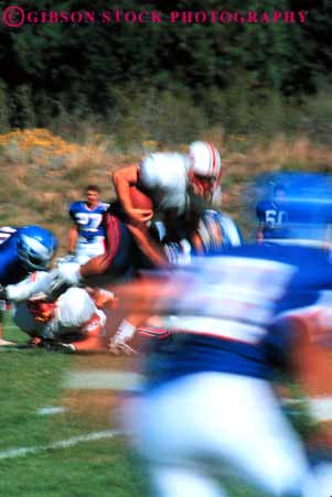 Stock Photo #5643: keywords - action ball blur college compete competing competition competitive competitor contact coordinate coordination defense defensive dynamic fast field fit fitness football game injury loose looser man men motion move movement moving offense offensive pass physical plan practice quarterback rule rules run rush score speed sport tackle team throw uniform uniforms unity vert violent win winner