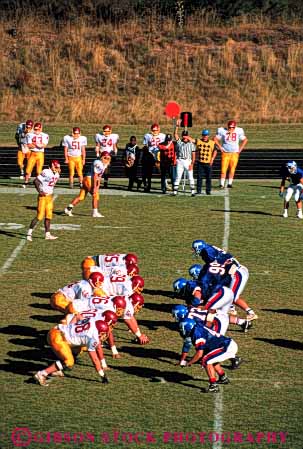 Stock Photo #5645: keywords - action ball college compete competing competition competitive competitor contact coordinate coordination defense defensive elevated field fit fitness football game injury line loose looser man men move movement offense offensive opposed opposition pass physical plan practice rule rules run score scrimmage sport tackle team throw uniform uniforms unity vert view violent win winner