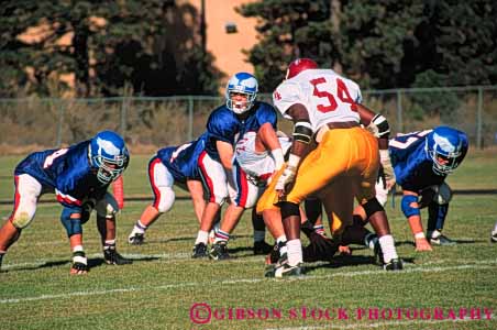 Stock Photo #5651: keywords - action ball college compete competing competition competitive competitor contact coordinate coordination defense defensive field fit fitness football game horz injury line loose looser man men move movement offense offensive oppose opposition pass physical plan practice rule rules run score scrimmage sport sports tackle team throw uniform uniforms unity violent win winner