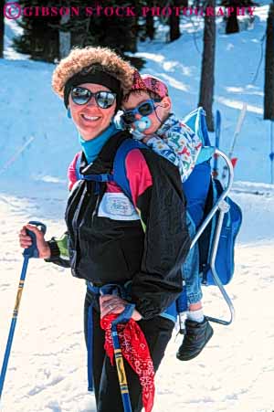 Stock Photo #5712: keywords -  baby backpack balance carry child children cold downhill effort equipment happy infant load mother outdoor outdoors outside pack parent portrait pose recreation released resort season single ski skier skiers skiing smile snow sport sports travel trip vacation vert winter