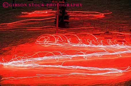 Stock Photo #5745: keywords -  abstract action blur bright display downhill evening flare horz light lighting lights motion move movement moving night parade pink red ski skier skiers skiing slope torch winter