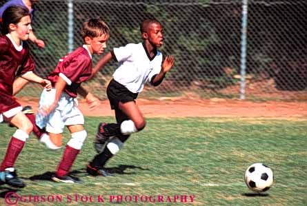 Stock Photo #5751: keywords -  action active adolescent adolescents african american and ball black blur blurred both boys child children compete competing competition competitor cooperate cooperating cooperative coordinate effort elementary ethnic exercise fast fitness gender genders girl goal horz kick kid kids minority mix mixed mixture motion movement moving physical plan race racer racers racing ran recreation run runner runners running runs school soccer social speed sport sports team teams uniform uniforms workout youth