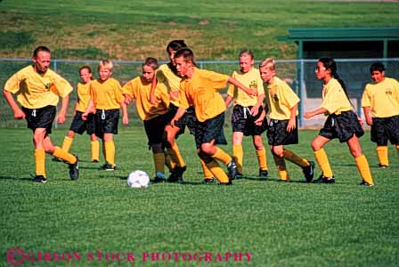 Stock Photo #5755: keywords - active african american ball black boys child children compete competing competition competitor cooperate cooperating cooperative coordinate effort elementary ethnic exercise fitness girls goal horz kick minority mixed physical plan ran recreation run runner running school soccer social sport team uniform uniforms workout youth
