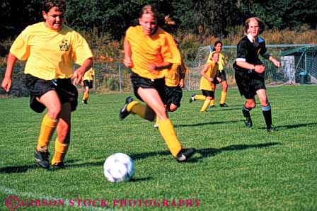 Stock Photo #5758: keywords - active ball boys child children coed compete competing competition competitor cooperate cooperating cooperative coordinate effort exercise fitness gender girls goal horz kick middle mixed physical plan ran recreation run runner running school soccer social sport team uniform uniforms workout youth