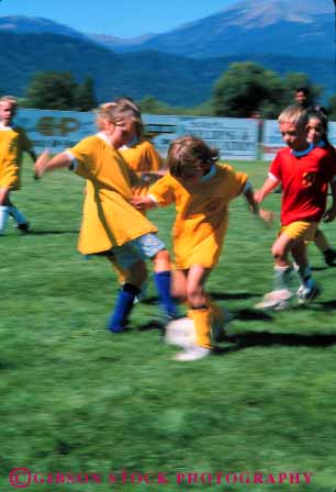 Stock Photo #5759: keywords - action active ball blur boys child children coed compete competing competition competitor cooperate cooperating cooperative coordinate dynamic effort elementary exercise fitness gender girls goal kick mixed motion move movement moving physical plan ran recreation run runner running school soccer social sport team uniform uniforms vert workout youth