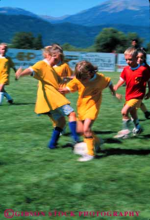 Stock Photo #5759: keywords -  action active ball blur boys child children coed compete competing competition competitor cooperate cooperating cooperative coordinate dynamic effort elementary exercise fitness gender girls goal kick mixed motion move movement moving physical plan ran recreation run runner running school soccer social sport team uniform uniforms vert workout youth