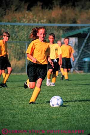 Stock Photo #5760: keywords -  active ball boys child children coed compete competing competition competitor cooperate cooperating cooperative coordinate effort exercise fitness gender girls goal kick middle mixed physical plan ran recreation run runner running school soccer social sport team uniform uniforms vert workout youth