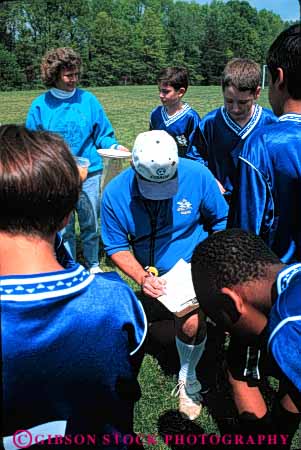 Stock Photo #5762: keywords -  active ball boys child children coach compete competing competition competitor cooperate cooperating cooperative coordinate effort ethnic exercise fitness goal kick middle mixed physical plan ran recreation run runner running school soccer social sport team uniform uniforms vert workout youth