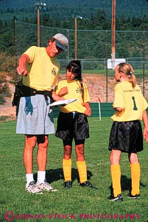 Stock Photo #5763: keywords -  active ball child children coach compete competing competition competitor cooperate cooperating cooperative coordinate effort ethnic exercise fitness girls goal kick middle minority mixed physical plan ran recreation run runner running school soccer social sport team uniform uniforms vert workout youth