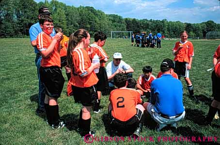 Stock Photo #5764: keywords - active ball boys child children coach compete competing competition competitor cooperate cooperating cooperative coordinate effort exercise fitness gender girls goal horz kick middle mixed physical plan ran recreation run runner running school soccer social sport team uniform uniforms workout youth