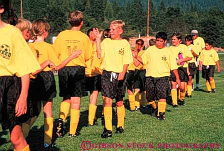 Stock Photo #5770: keywords -  active ball child children compete competing competition competitor congratulations cooperate cooperating cooperative coordinate effort ethnic exercise fitness gender goal horz kick middle minority mixed physical plan ran recreation run runner running school soccer social sport team teams uniform uniforms workout yellow youth