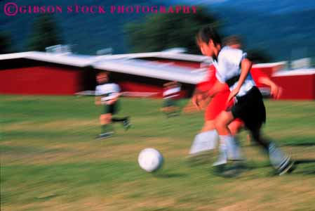 Stock Photo #5774: keywords - action active ball blur boys child children compete competing competition competitor cooperate cooperating cooperative coordinate dynamic effort exercise fitness goal horz kick middle move movement moving physical plan ran recreation run runner running school soccer social sport team uniform uniforms workout youth