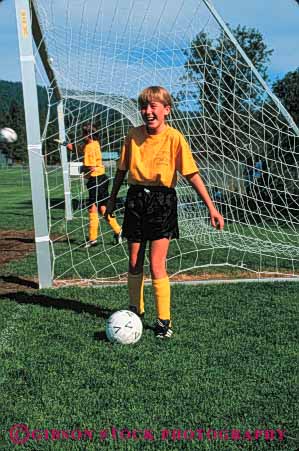 Stock Photo #5775: keywords -  active ball child children compete competing competition competitor cooperate cooperating cooperative coordinate effort exercise fitness girl goal kcick middle physical plan portrait ran recreation released run runner running school soccer social sport team uniform uniforms vert workout youth