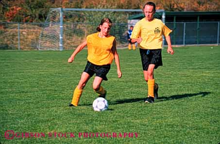 Stock Photo #5776: keywords -  action active ball child children compete competing competition competitor cooperate cooperating cooperative coordinate effort exercise fitness girls goal horz kick middle physical plan ran recreation run runner running school soccer social sport team uniform uniforms workout youth