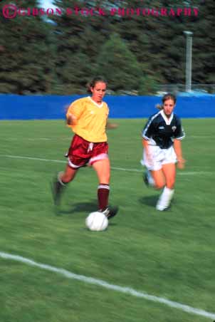 Stock Photo #5777: keywords -  action active adult athlete athletic ball blur college compete competing competition competitor cooperate cooperating cooperative coordinate dynamic effort exercise female fitness goal kick motion move movement physical plan ran recreation run runner running school soccer social speed sport student team uniform uniforms vert woman womans women workout youth