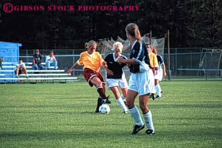 Stock Photo #5778: keywords - action active adult athlete athletic ball blur college compete competing competition competitor cooperate cooperating cooperative coordinate dynamic effort exercise female fitness goal horz kick motion move movement physical plan ran recreation run runner running school soccer social speed sport student team uniform uniforms woman womans women workout youth