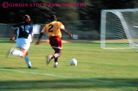 Stock Photo #5779: keywords - action active adult african american athlete athletic ball blur college compete competing competition competitor cooperate cooperating cooperative coordinate dynamic effort ethnic exercise female fitness goal horz kick minority motion move movement moving physical plan ran recreation run runner running school soccer social speed sport student team uniform uniforms woman womans women workout youth