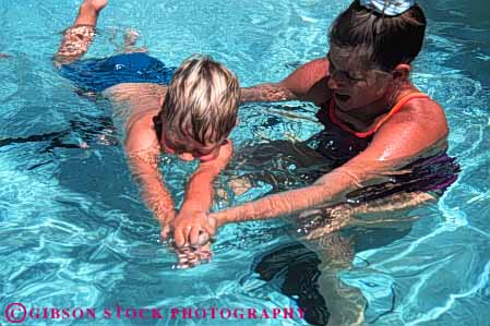Stock Photo #5803: keywords -  boy career cool fun girl horz job learn occupation outdoor outdoors outside play pool practice recreation refresh refreshing released sport summer swim swimmer swimmers swimming teach teacher warm water wet woman work
