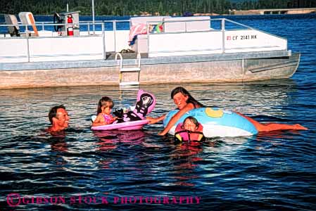 Stock Photo #5805: keywords -  boat child children cool family father float fun horz husband lake laugh mother outdoor outdoors outside patio play recreation refresh refreshing released resort river share sister smile sport summer swim swimmer swimmers swimming together vacation warm water wet wife