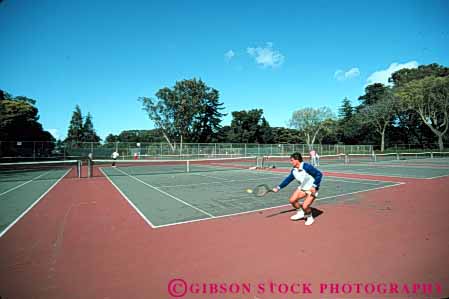 Stock Photo #5825: keywords -  agility backhand ball court exercise game hit horz man match motion move movement moving net opponent opposition outdoor outdoors outside pair play playing racket racquet rebound recreation run sport summer swing tennis vitality workout