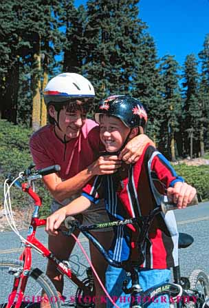 Stock Photo #5848: keywords - assist assistance balance bicycle bicycling bike care careful caution checks helmet help human mother pair peddle power recreation released ride roll son sport steer team transportation two vert wheel wheels