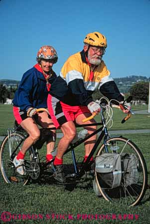 Stock Photo #5852: keywords -  balance bicycle bicycling bike colorful couple elderly exercise helmet helmets human husband mature old peddle power recreation released ride roll senior seniors sport steer tandem together transportation two vert wheel wheels wife